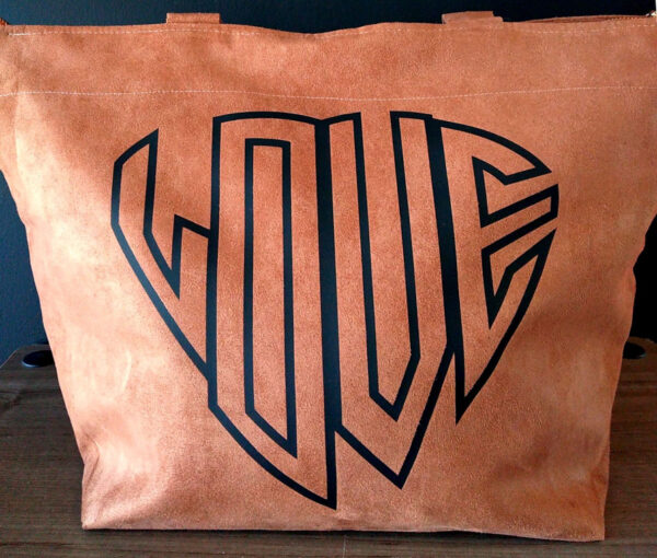 A close up of the word love on a bag