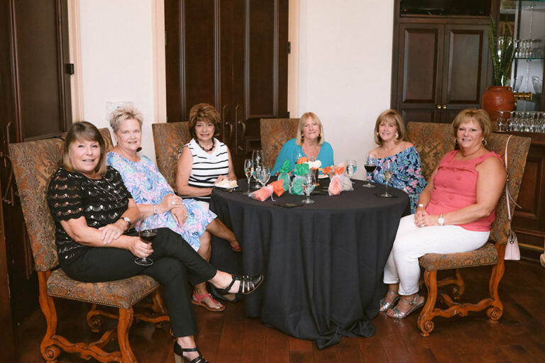 A group of women sitting around a table.