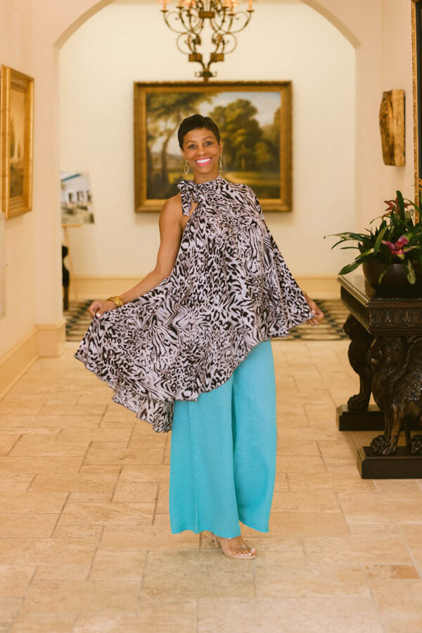 A woman standing in front of a painting.