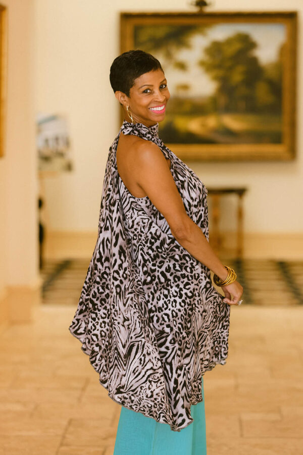 A woman standing in front of a painting.