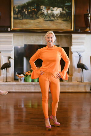A woman in orange standing on the floor