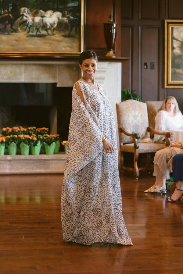 A woman in an elegant white dress standing on the floor.