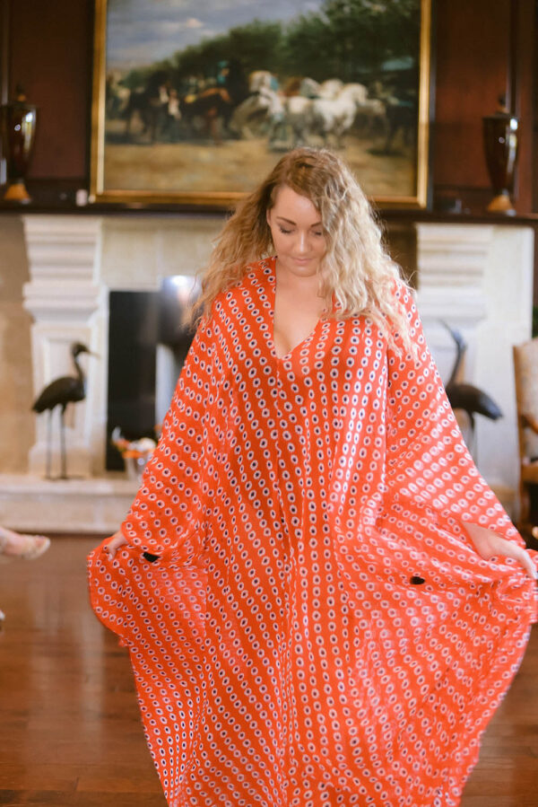 A woman in an orange and white dress