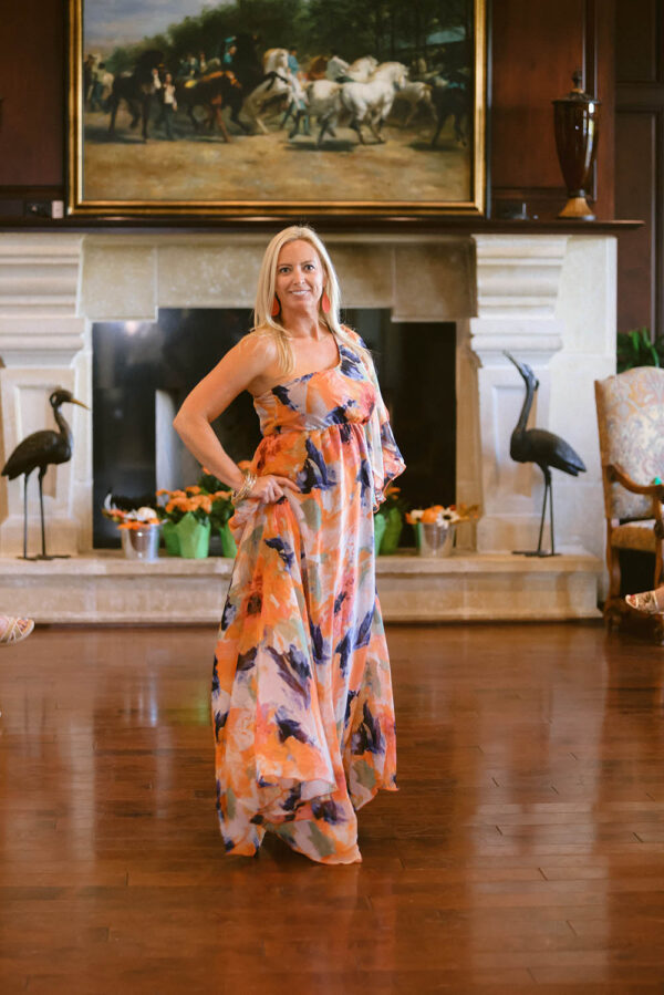 A woman standing in front of two birds.