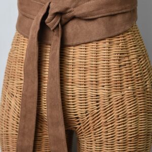 A close up of the waist belt on a wicker basket