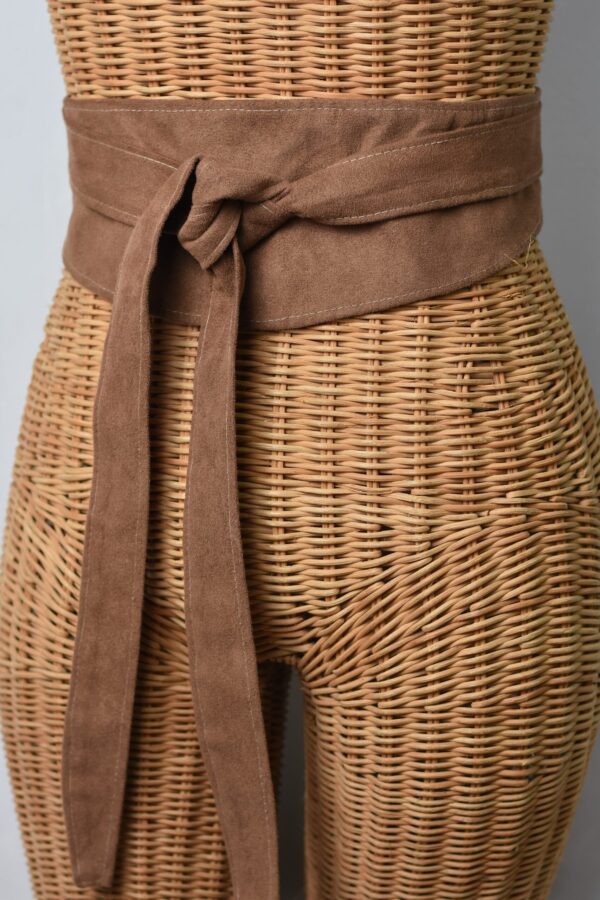 A close up of the waist belt on a wicker basket